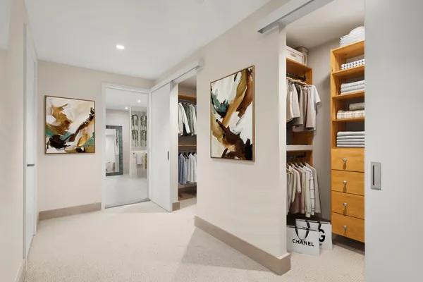 a view of a bedroom with walk in closet and bathroom