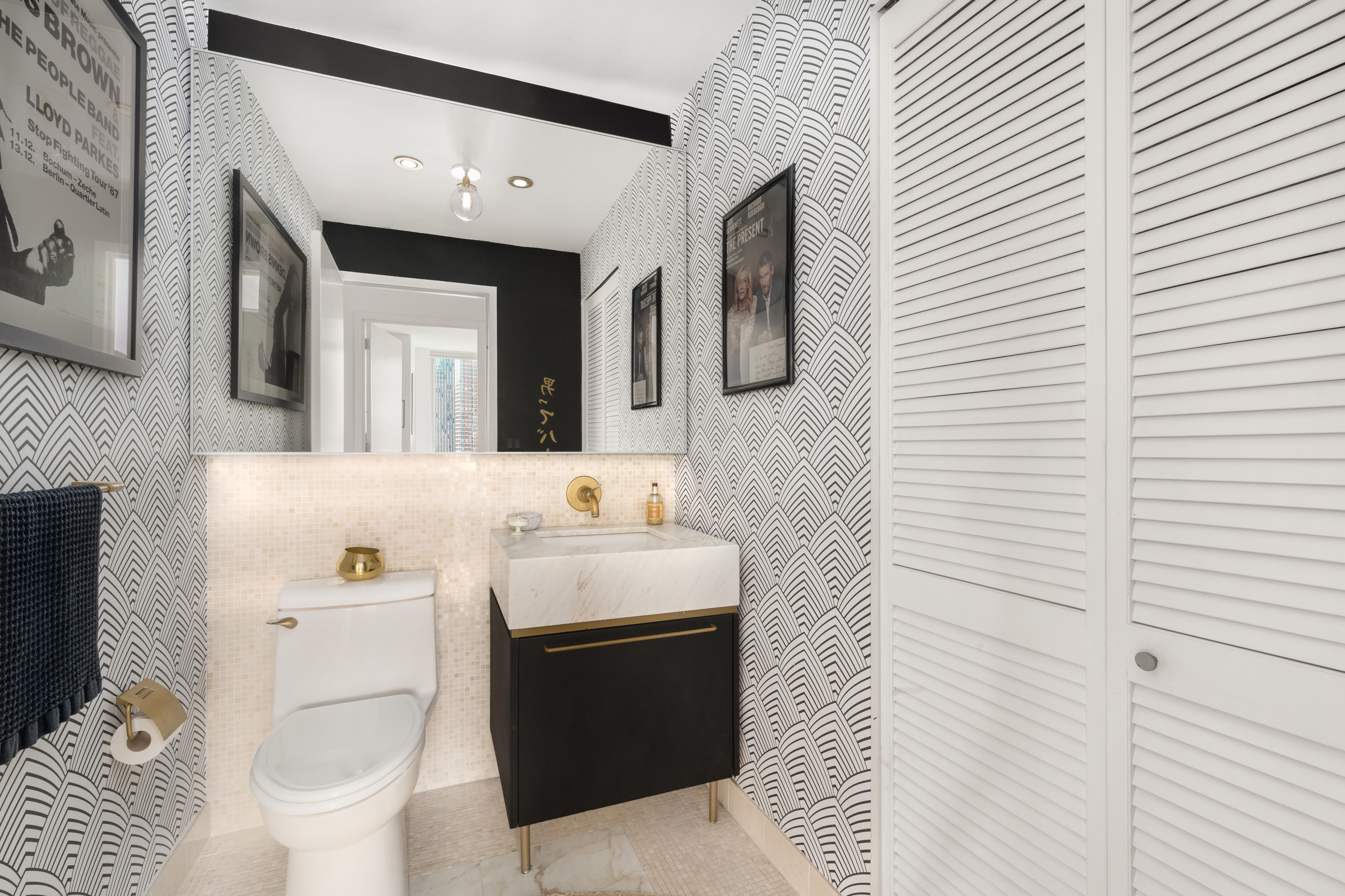 200 Chambers Street, Unit 25F Manhattan, NY 10007 - Photo 7 of 14 a bathroom with a sink toilet and mirror