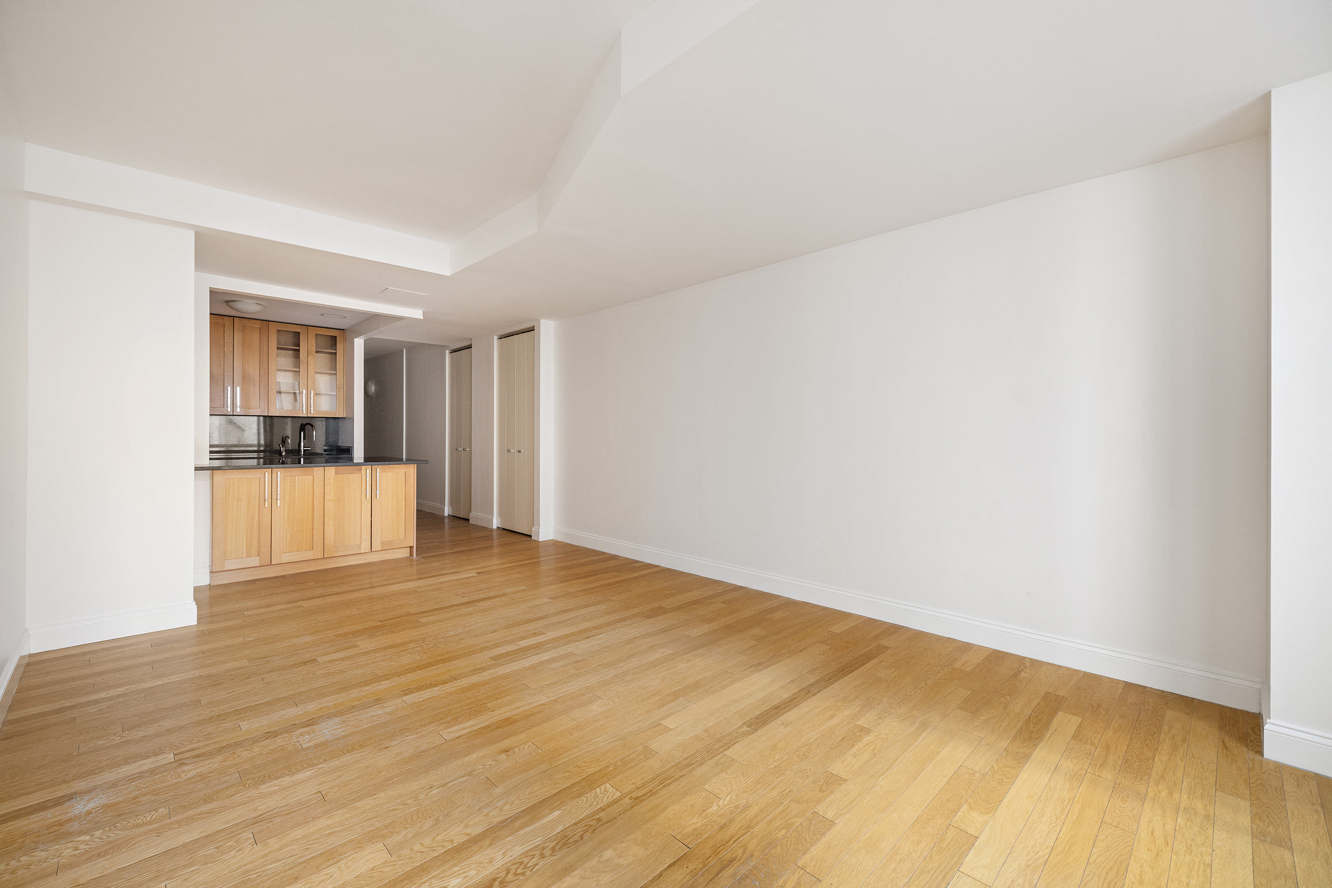 88 Greenwich Street, Unit 1014 Manhattan, NY 10006 - Photo 4 of 14 a view of empty room with wooden floor