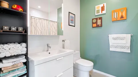 a bathroom with a sink a toilet and a shower curtain