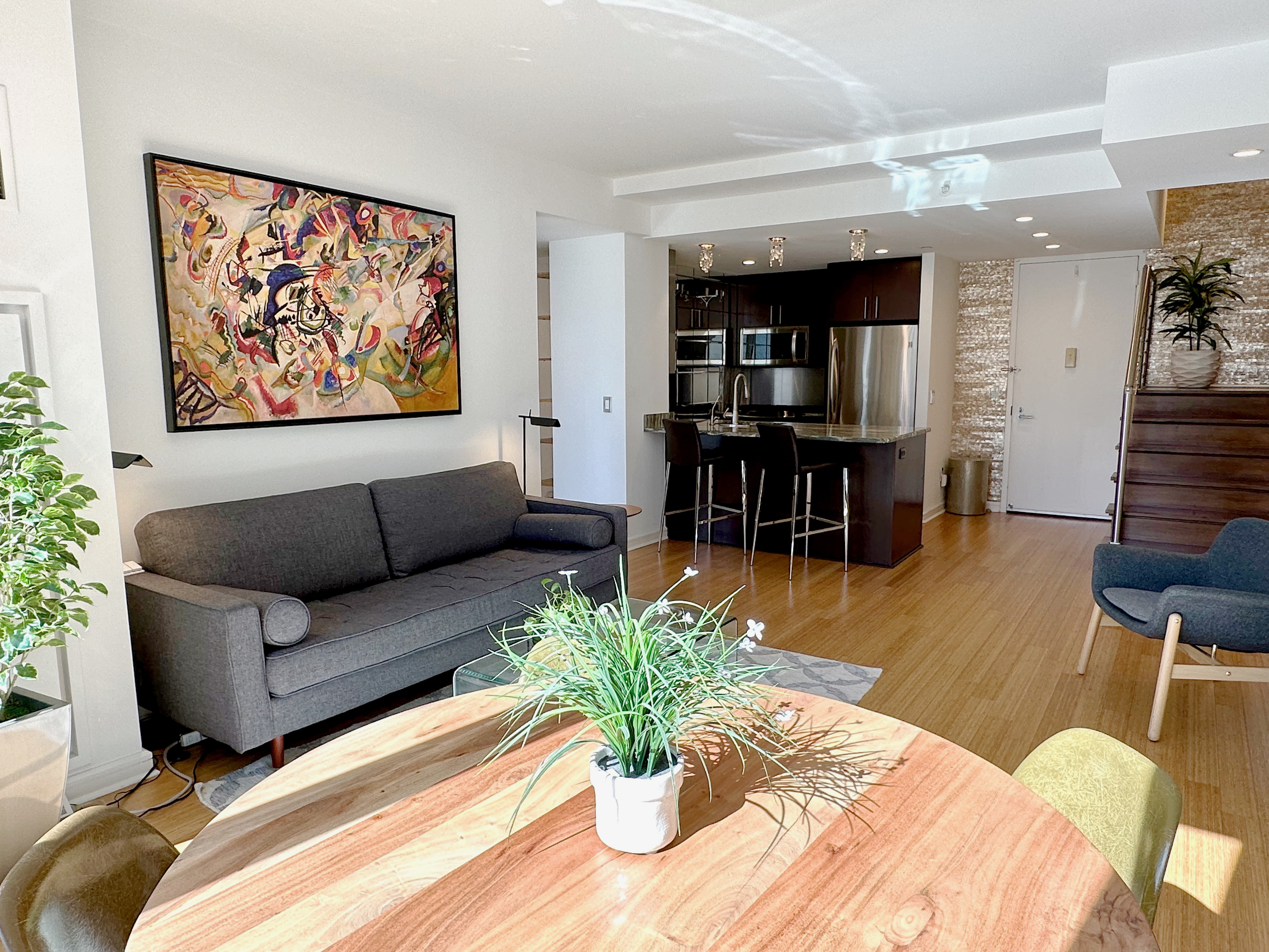 350 West 53rd Street, Unit PHA Manhattan, NY 10019 - Photo 6 of 35 a living room with furniture a dining table and a potted plant
