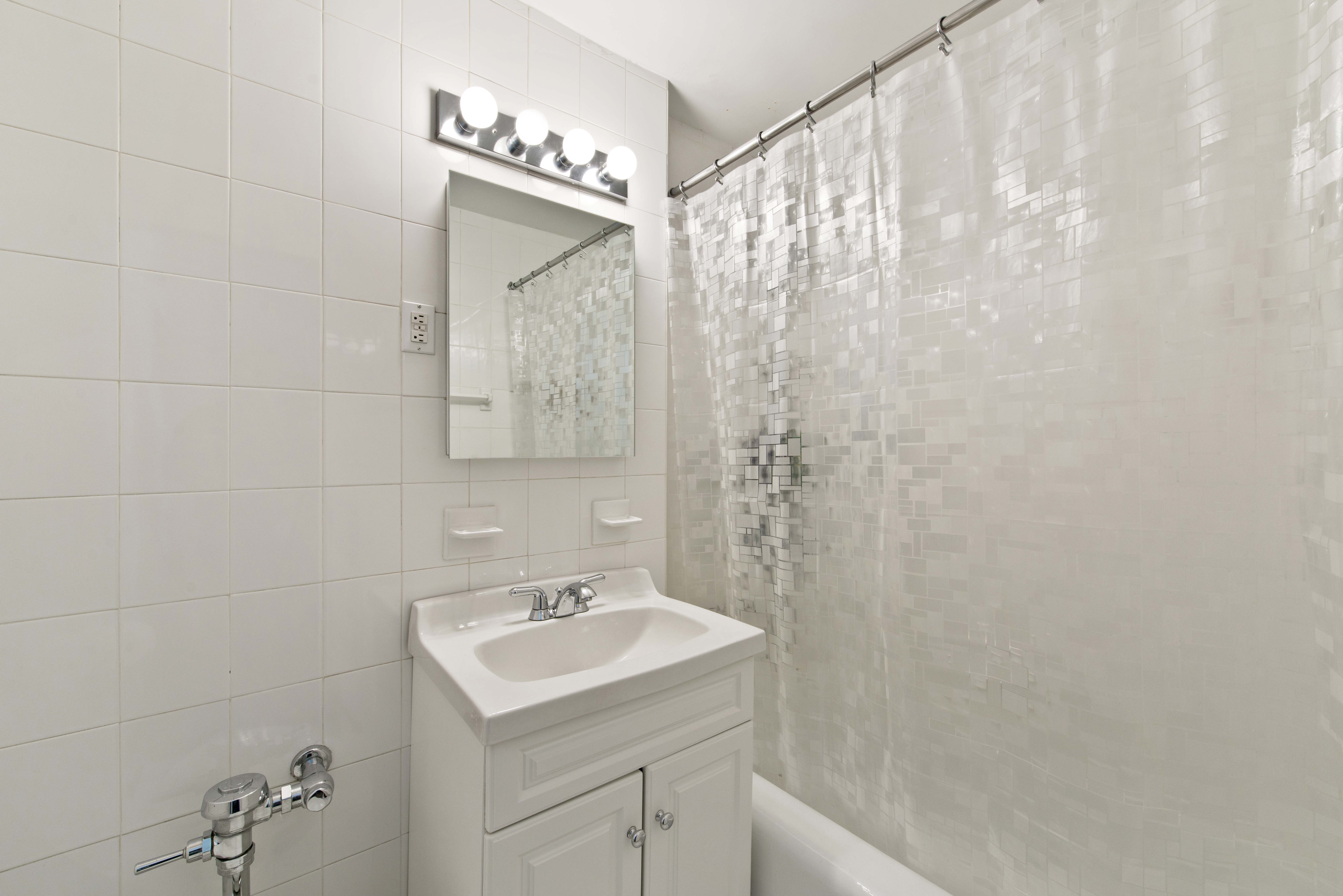 30 East 37th Street, Unit 6C Manhattan, NY 10016 - Photo 3 of 5 a bathroom with a sink and mirror