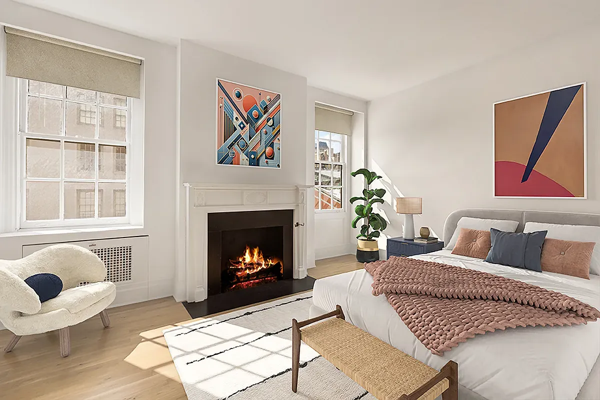 a bedroom with a bed and a fireplace