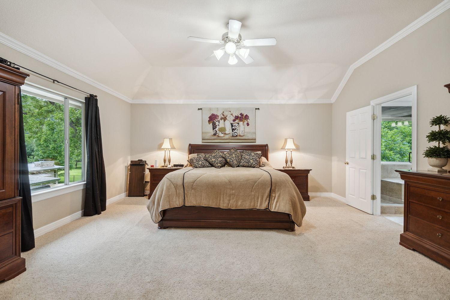 a spacious bedroom with a large bed and a window