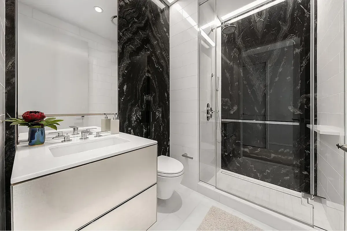 a bathroom with a sink toilet and shower