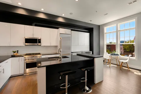 a kitchen with stainless steel appliances a stove sink microwave and cabinets