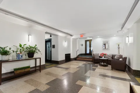a living room with furniture and flowers