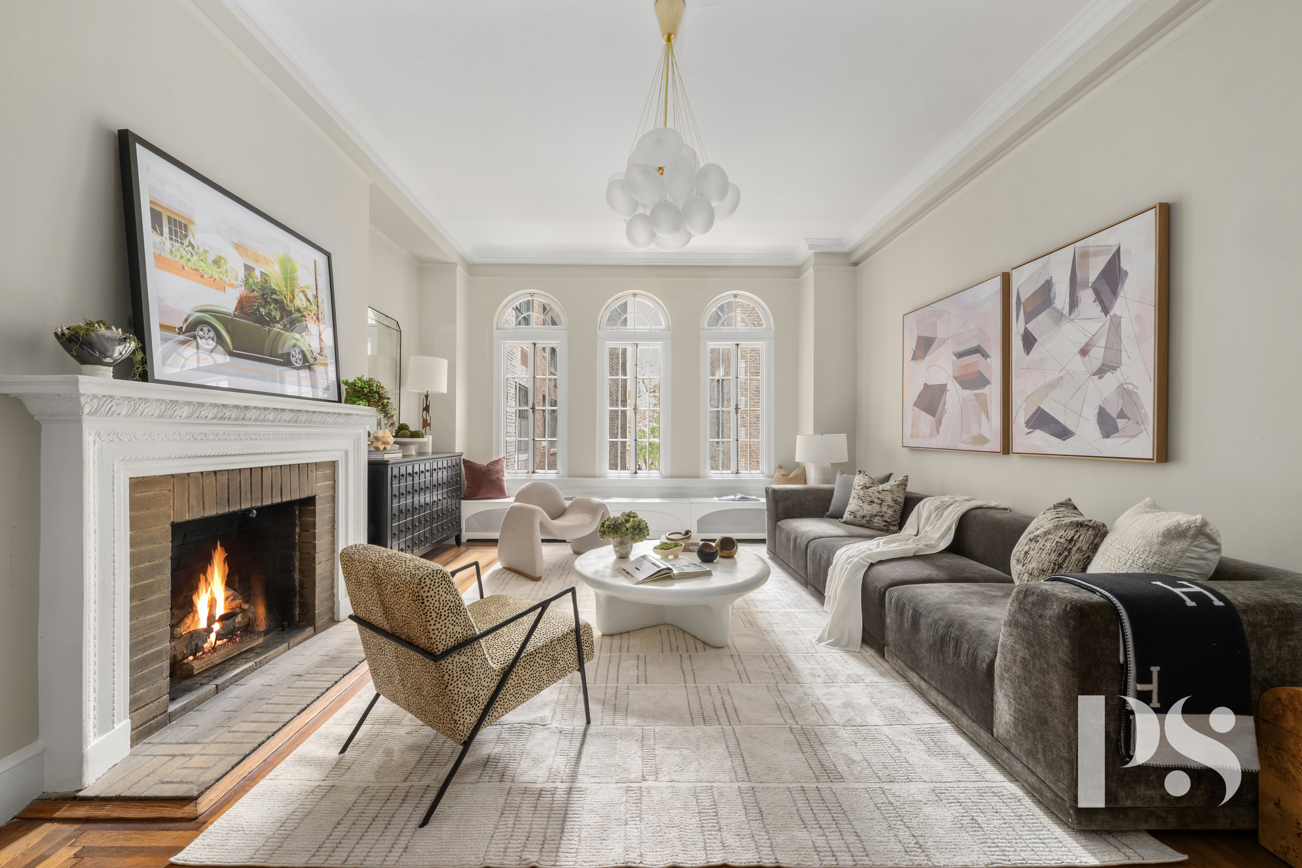 35 East 9th Street, Unit 33 Manhattan, NY 10003 - Photo 1 of 14 a living room with furniture a fireplace and a flat screen tv