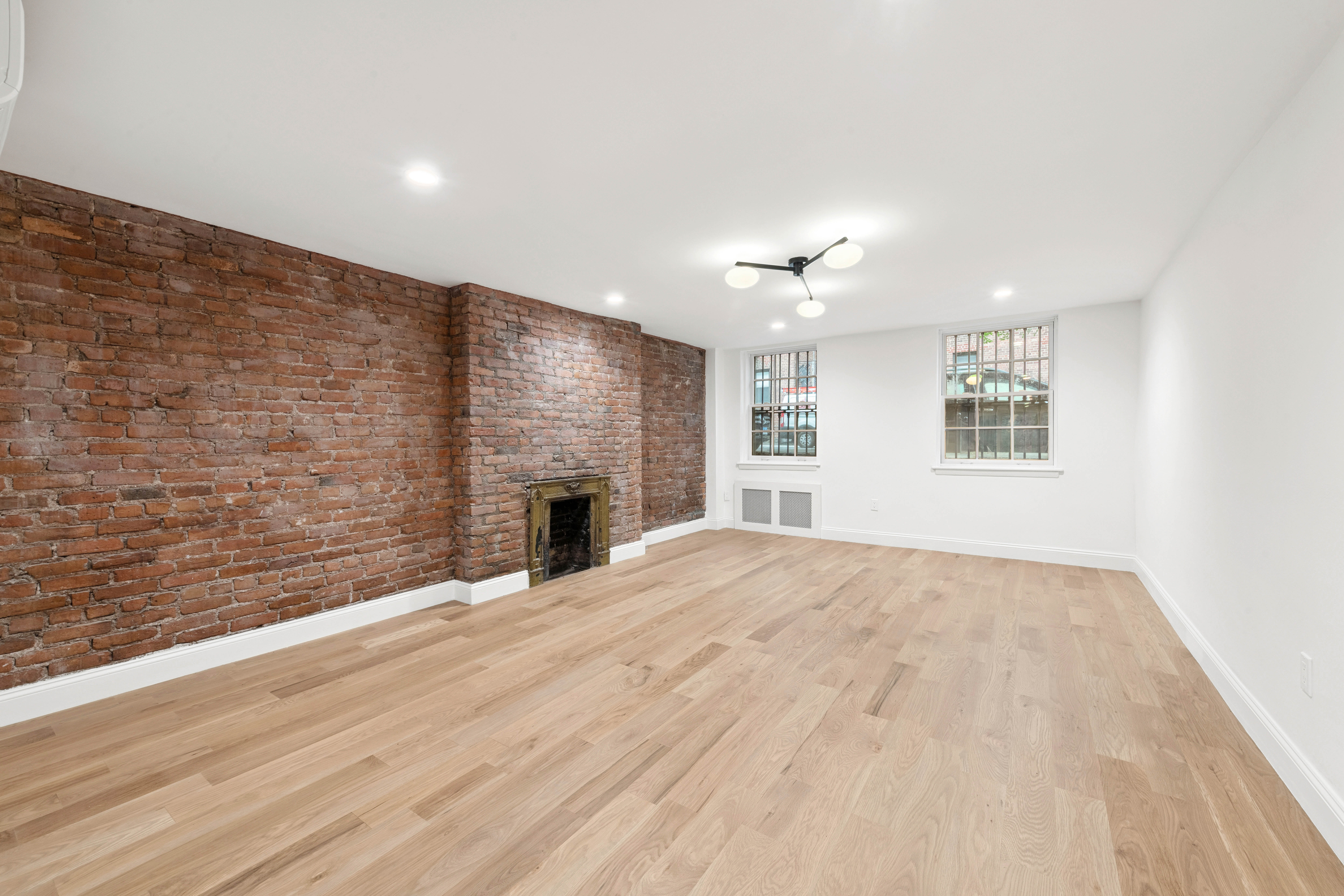 765 Greenwich Street, Unit 1 Manhattan, NY 10014 - Photo 6 of 14 a view of an empty room with a fireplace and a window
