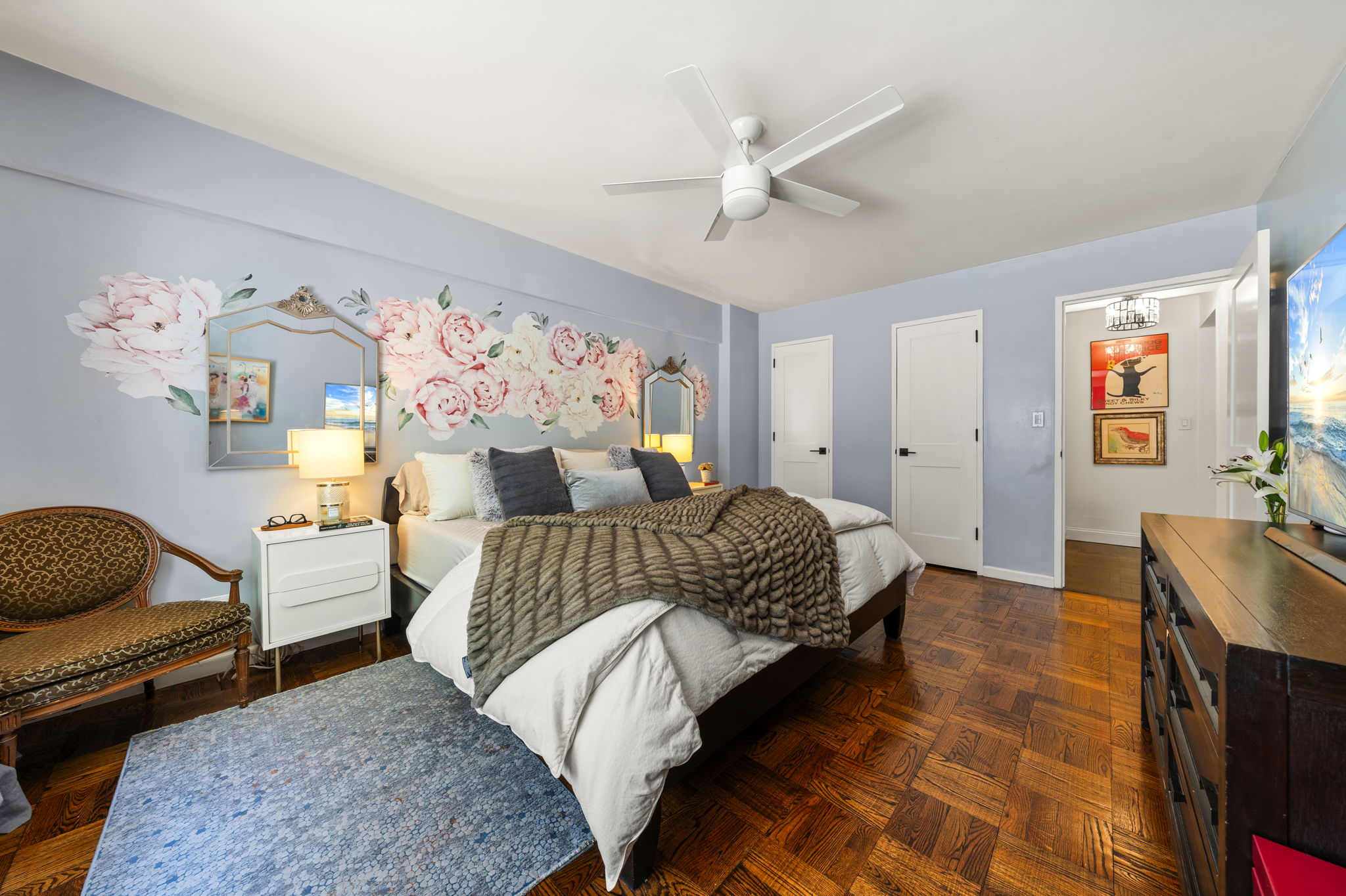 310 Lexington Avenue, Unit 2J Manhattan, NY 10016 - Photo 10 of 11 a bedroom with a bed and wooden floor