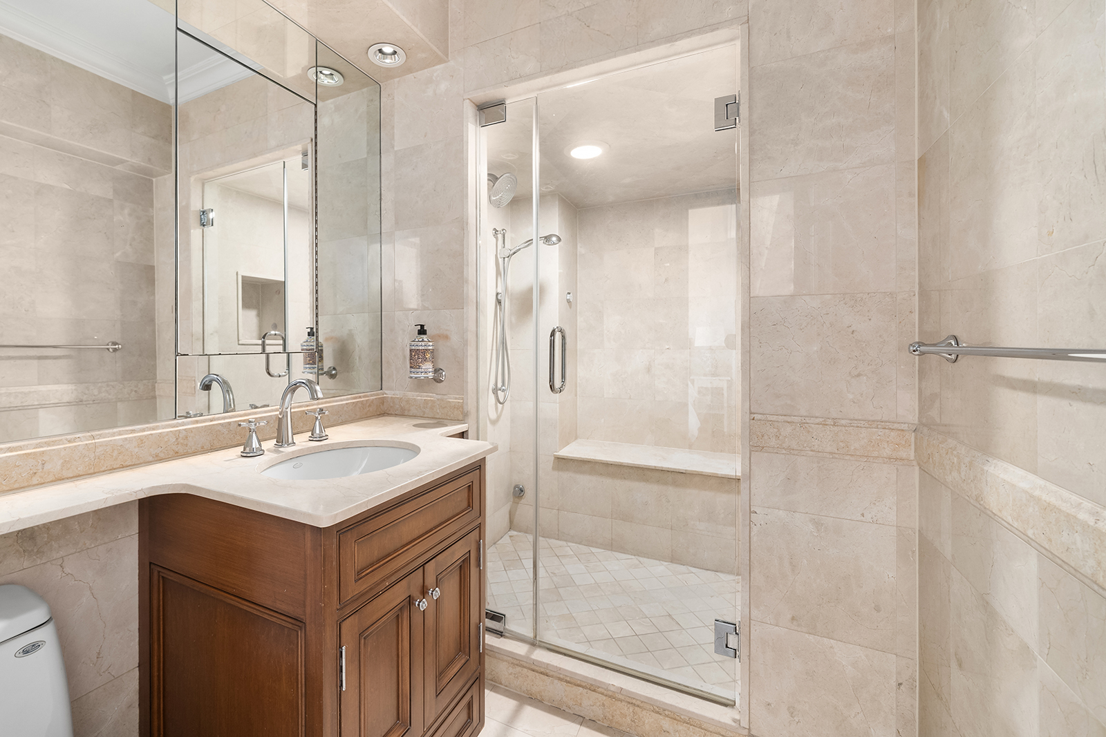 69 5th Avenue, Unit 17HJ Manhattan, NY 10003 - Photo 6 of 10 a bathroom with a shower sink vanity and mirror