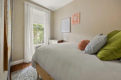 a bedroom with a bed and a window
