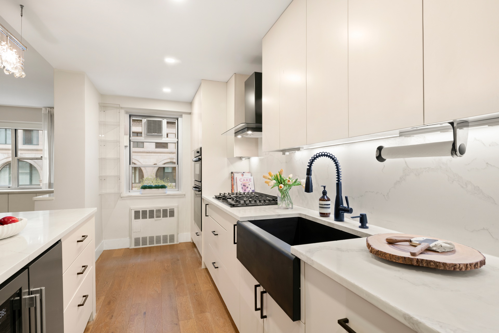70 East 10th Street, Unit 4V Manhattan, NY 10003 - Photo 7 of 26 a kitchen with a sink a stove and cabinets
