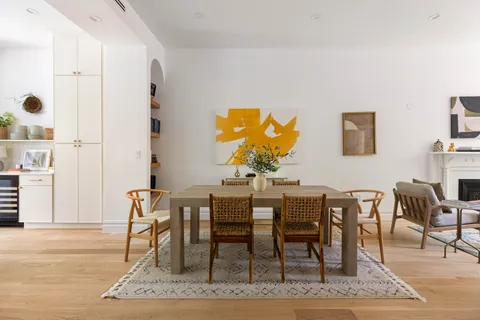 a view of a dining room with furniture and wooden floor