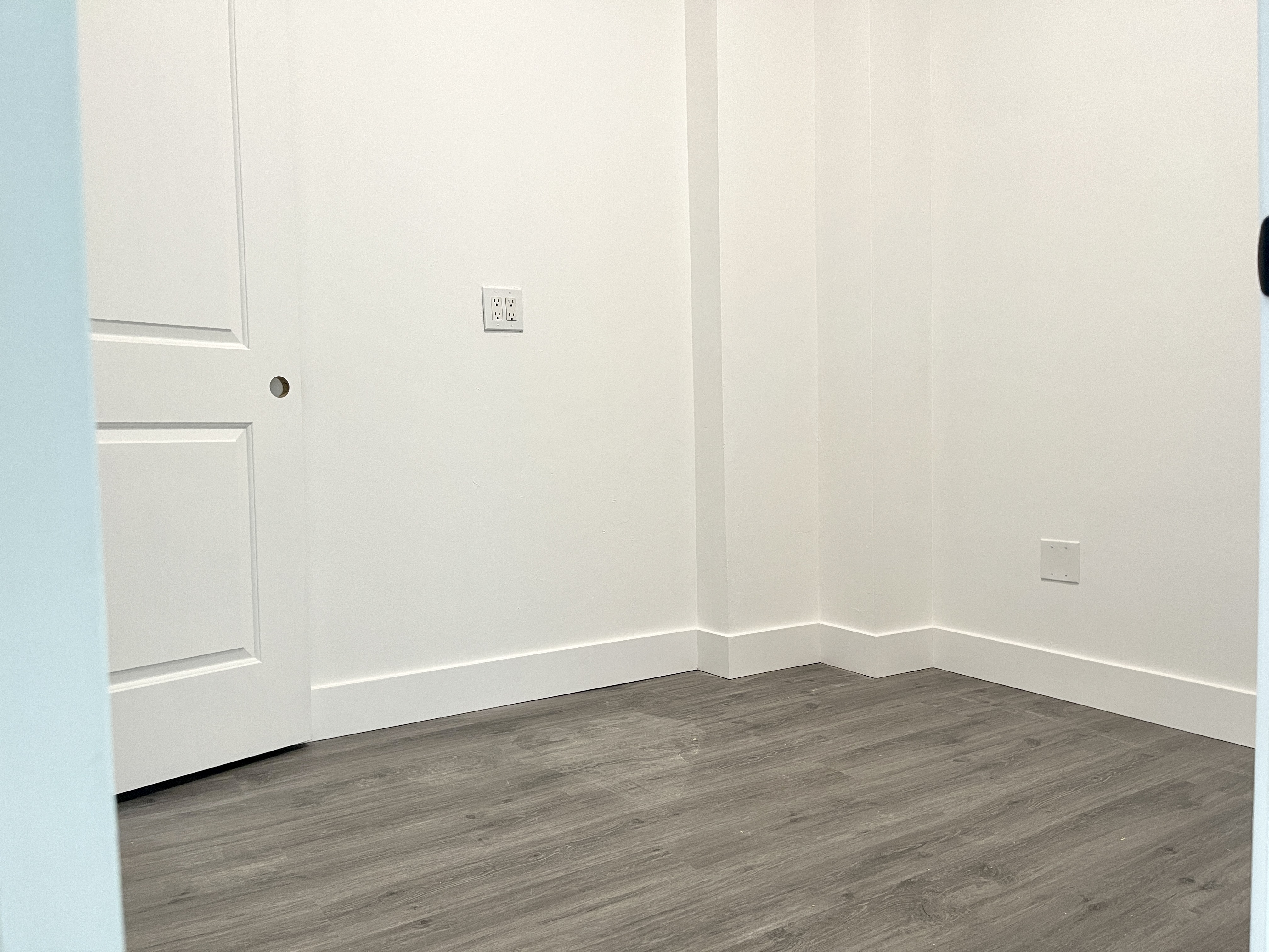 1999 3rd Avenue, Unit 1 Manhattan, NY 10029 - Photo 7 of 23 a view of an empty room with wooden floor
