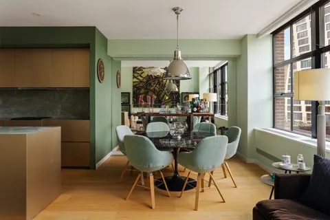 a dining room with furniture and window
