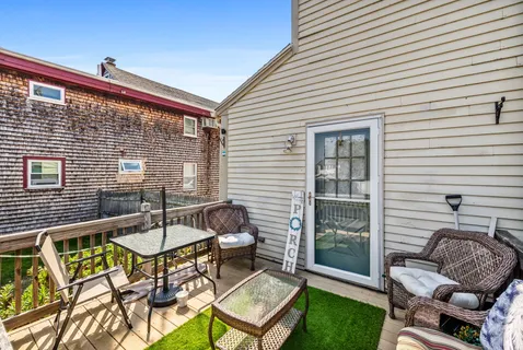 a backyard of a house with outdoor seating