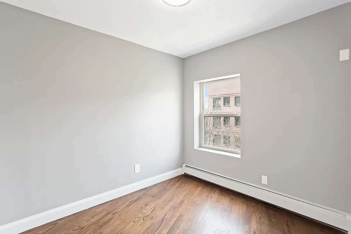 189 Woodpoint Road, Unit 4 Brooklyn, NY 11211 - Photo 4 of 6 an empty room with wooden floor and windows