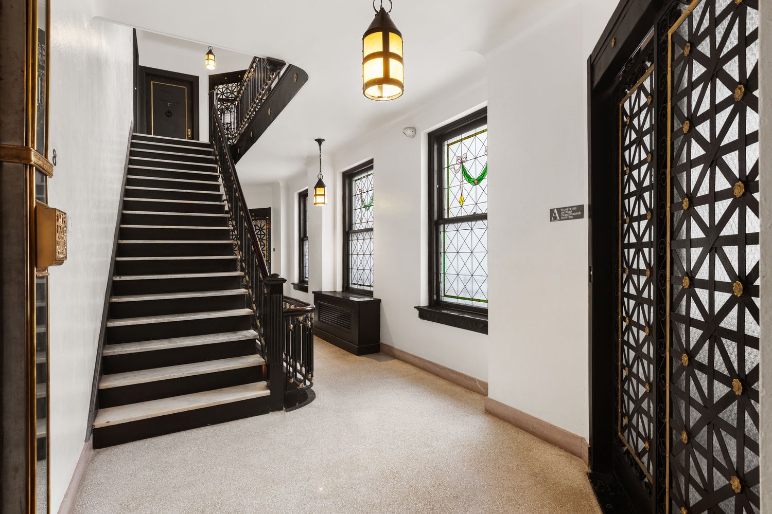 50 Central Park West, Unit 8BB Manhattan, NY 10023 - Photo 19 of 28 a view of a hallway with paintings on the wall