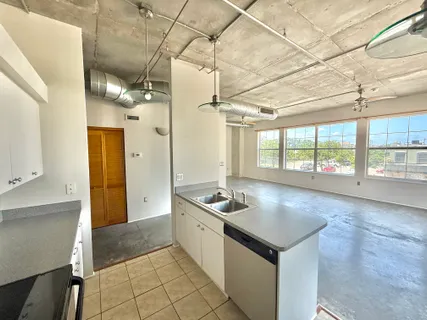 a kitchen with granite countertop a sink and a stove