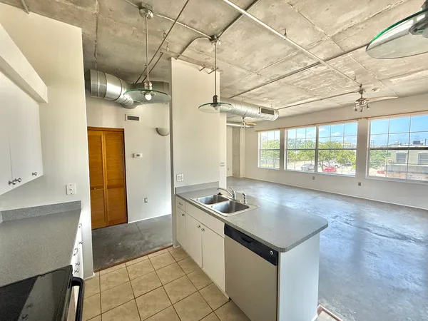 a kitchen with granite countertop a sink and a stove
