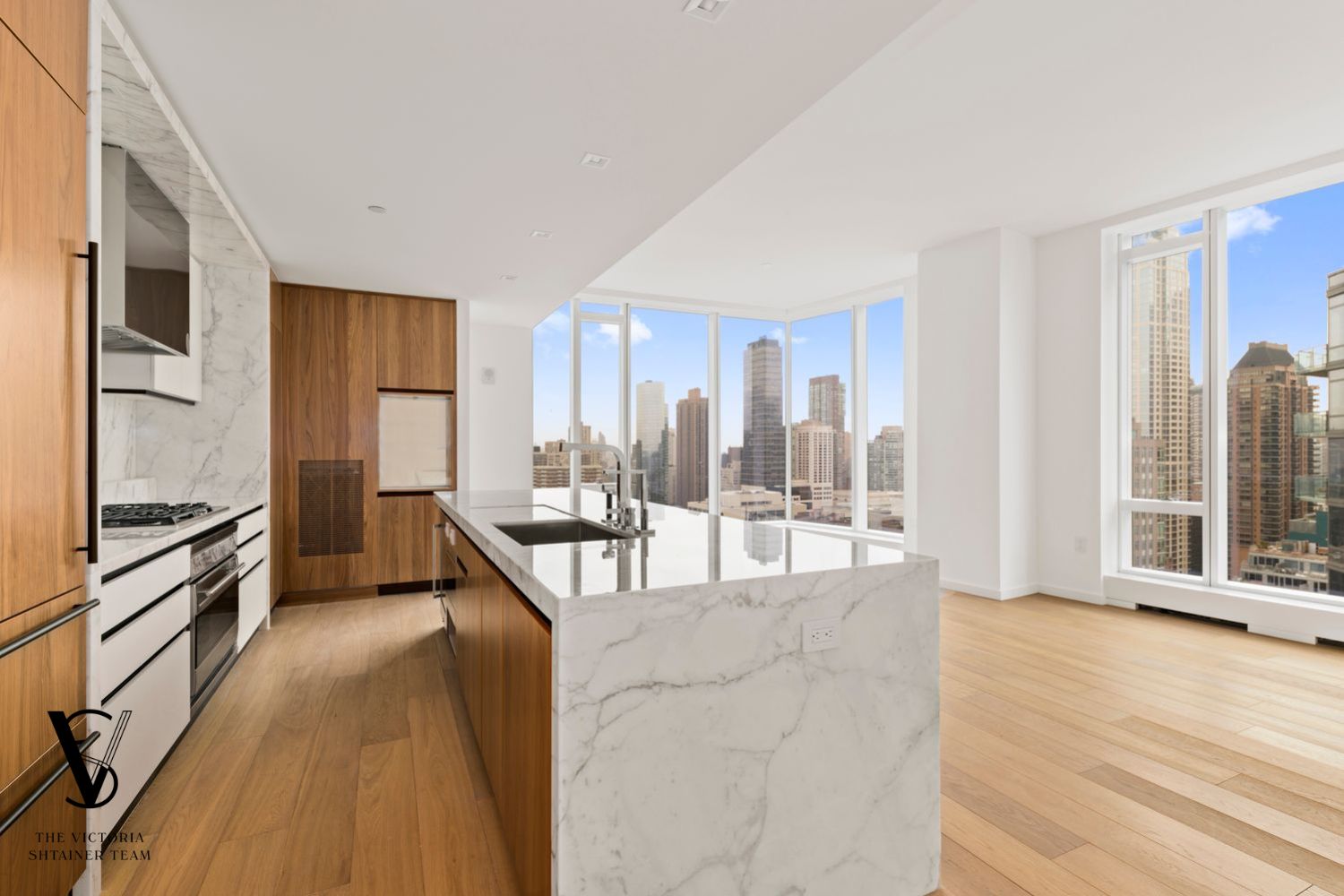1 West End Avenue, Unit C28 Manhattan, NY 10069 - Photo 5 of 26 a large living room with stainless steel appliances kitchen island granite countertop a large window and a wooden floors