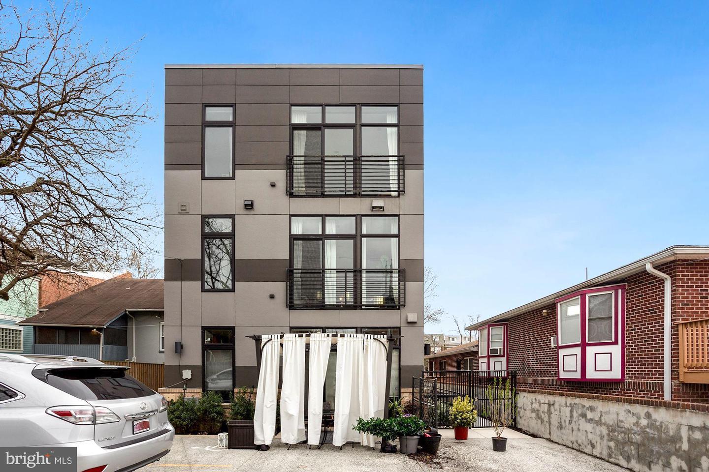 129 Varnum Street Northwest, Unit 6 Washington, DC 20011 - Photo 25 of 25 a front view of a residential apartment building with a yard