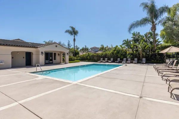 a view of a swimming pool and lounge chairs