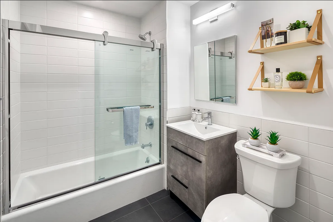 1425 Fulton Street, Unit 4A Brooklyn, NY 11216 - Photo 4 of 12 a bathroom with a sink toilet and shower