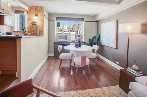 a bedroom with furniture and a wooden floor
