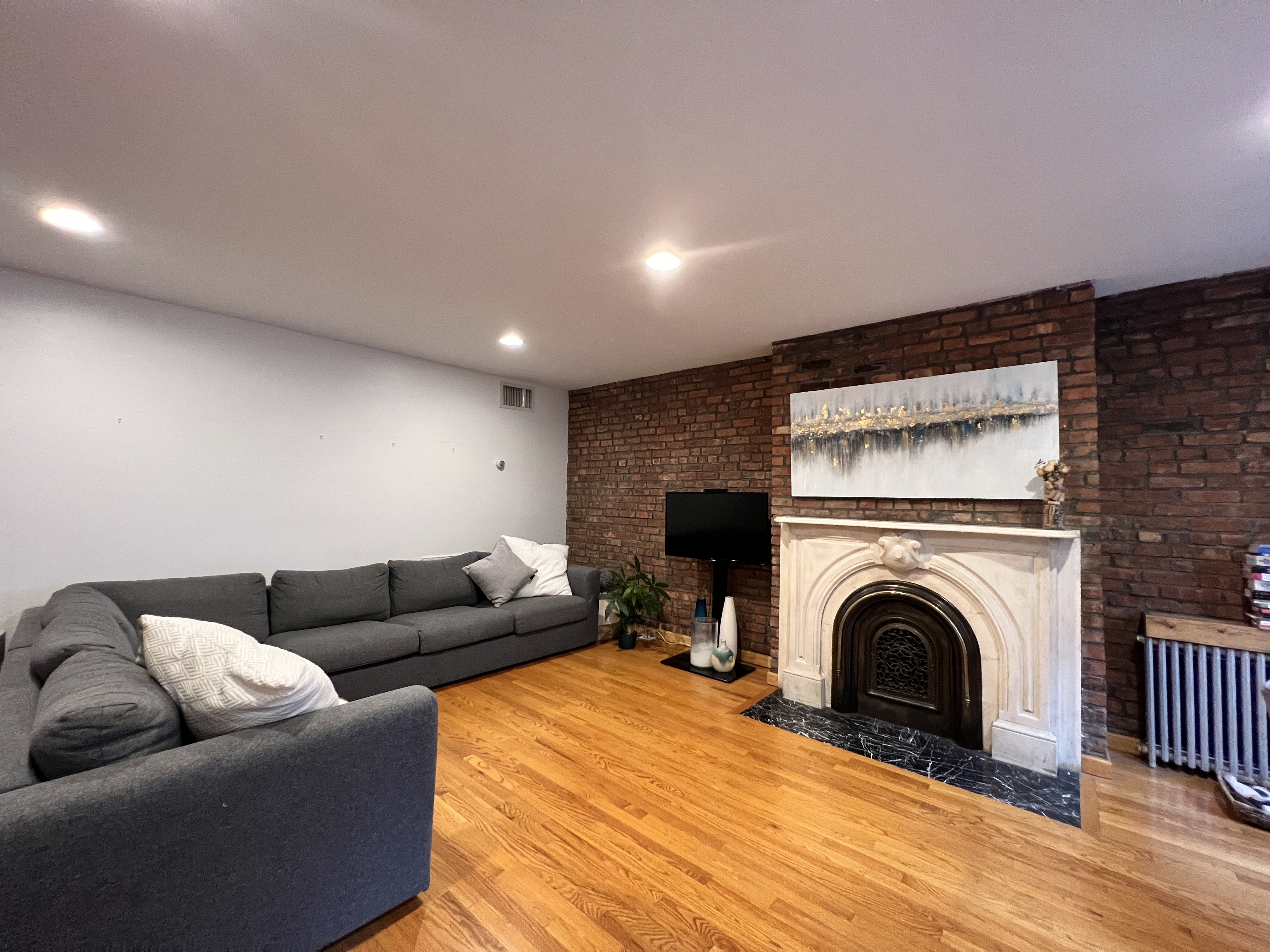 75 Warren Street, Unit 1 Brooklyn, NY 11201 - Photo 2 of 14 a living room with furniture and a fireplace