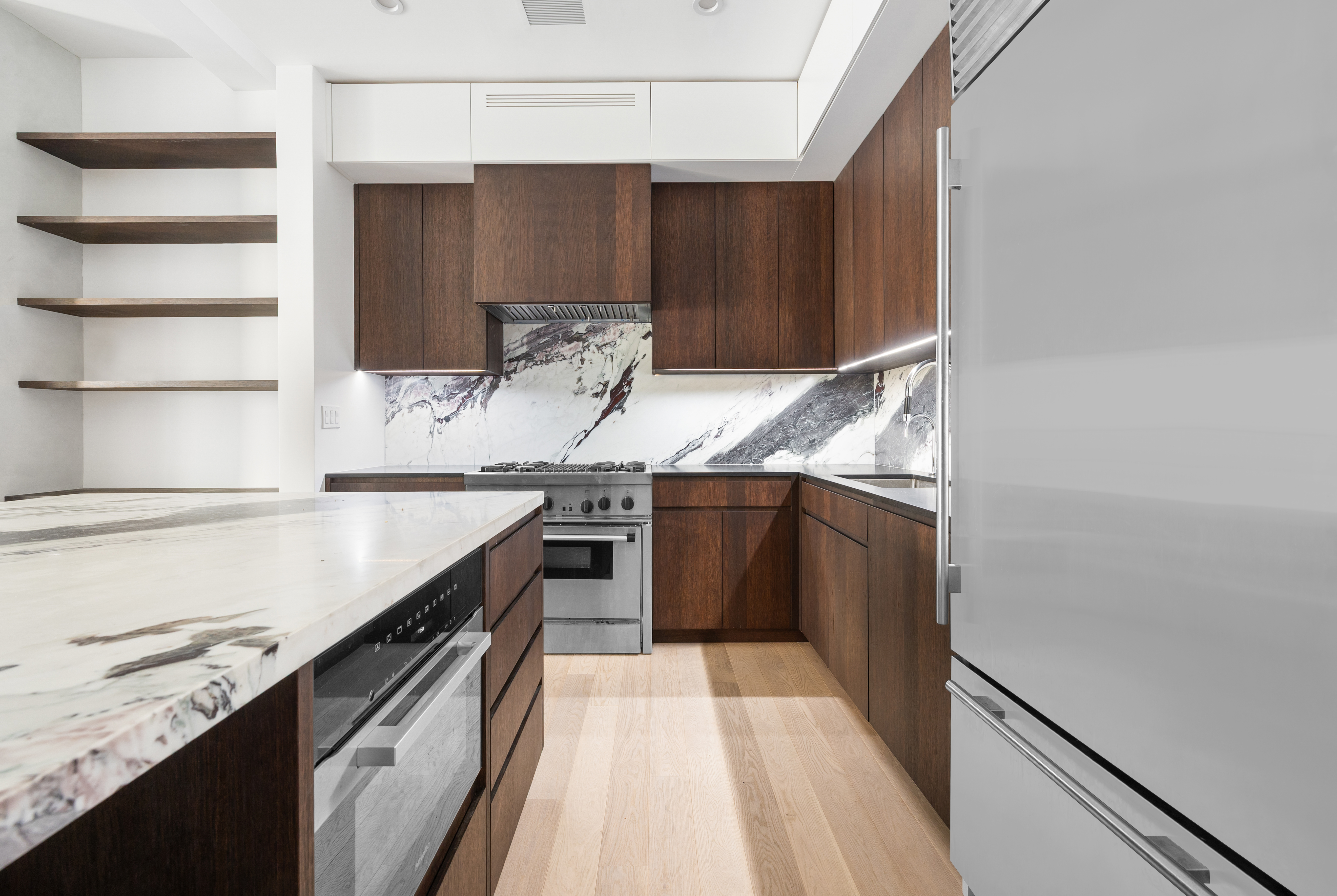 69 Bank Street, Unit 203 Manhattan, NY 10014 - Photo 7 of 23 a kitchen with stainless steel appliances granite countertop a sink and a stove