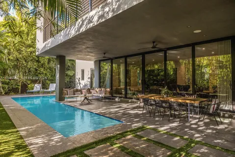 a view of a swimming pool with chairs in patio