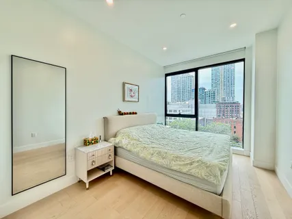 a bedroom with a bed and large window