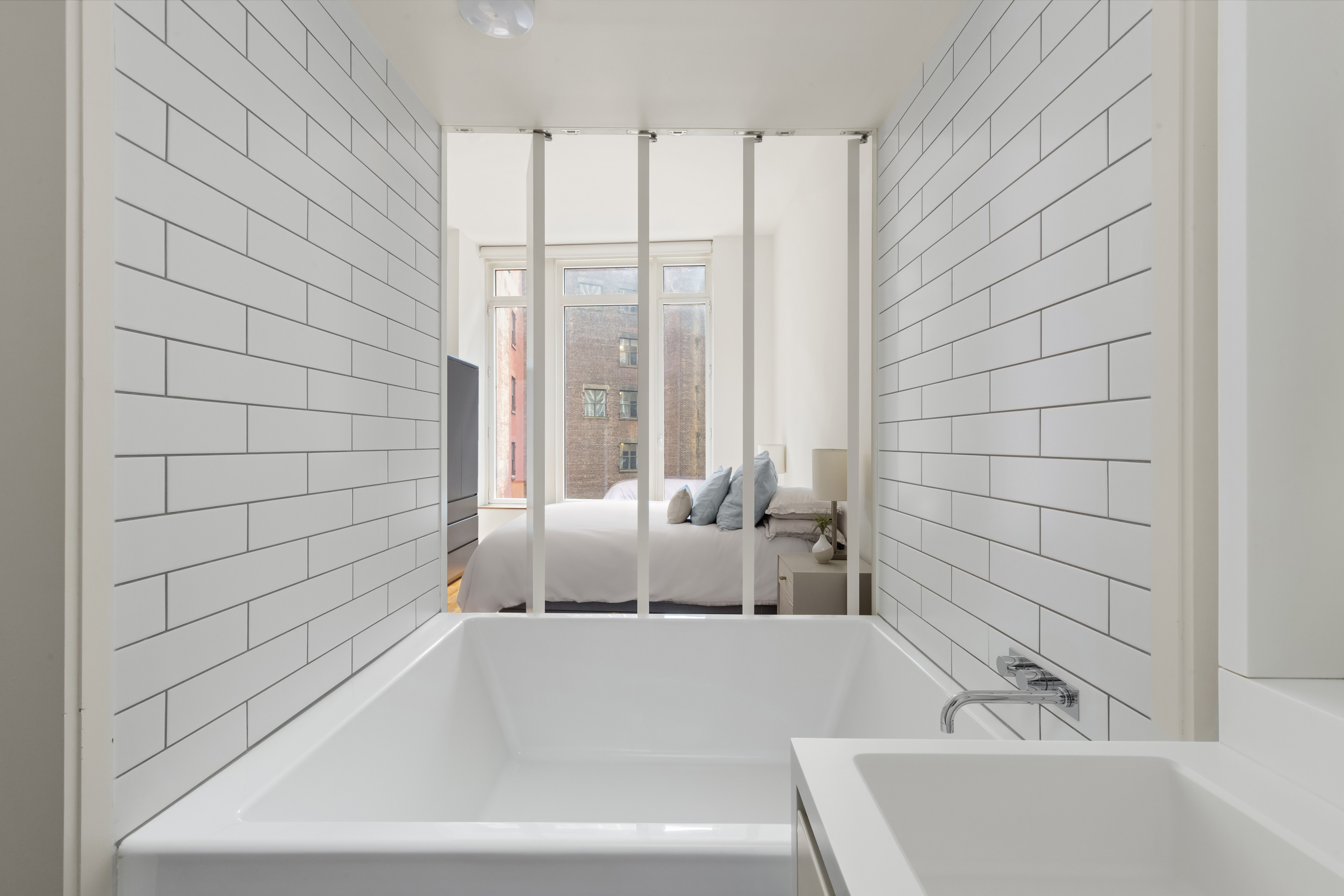 15 William Street, Unit 7B Manhattan, NY 10005 - Photo 7 of 9 a bathroom with a bathtub and shower