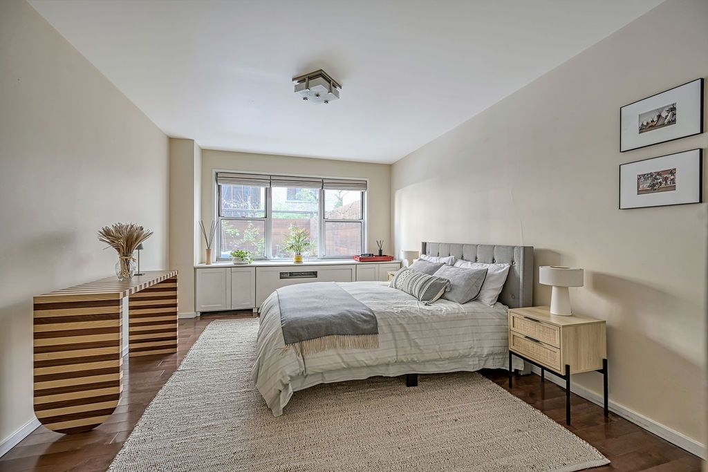 a bedroom with a bed and a large window