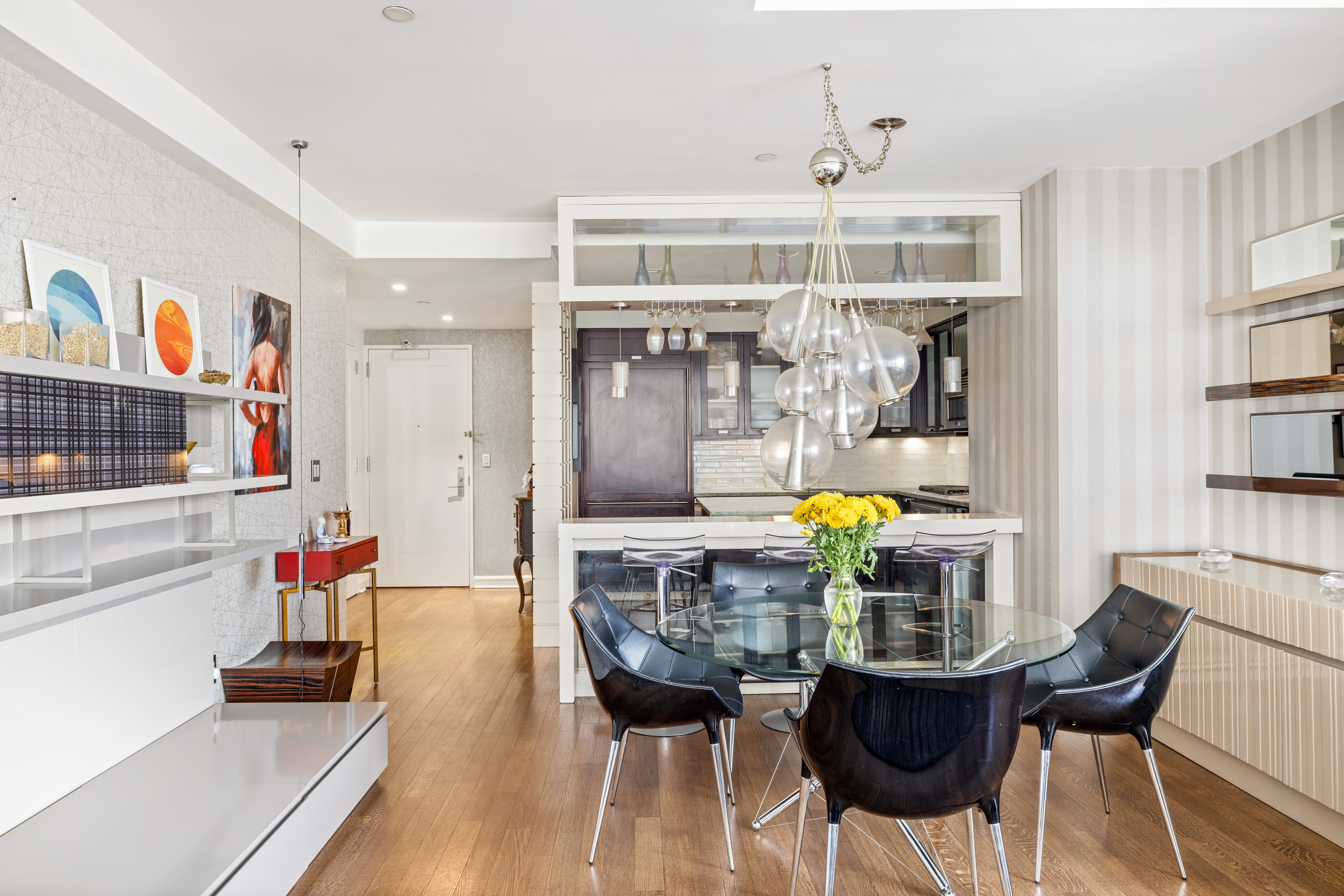 80 Riverside Boulevard, Unit 7E Manhattan, NY 10069 - Photo 4 of 12 a living room with stainless steel appliances furniture and a chandelier