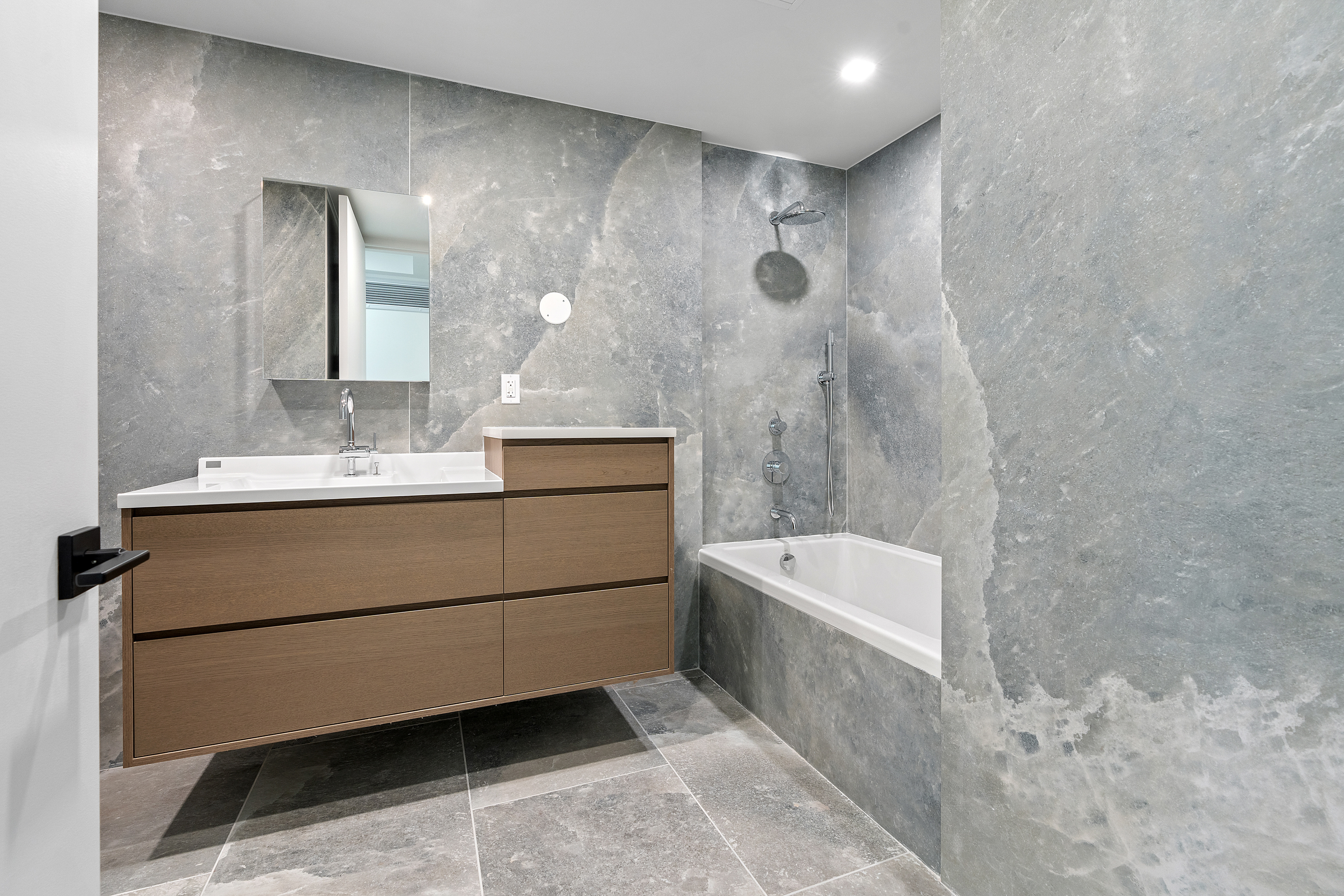 327 East 22nd Street, Unit 3A Manhattan, NY 10010 - Photo 12 of 14 a bathroom with a sink a bathtub and a mirror