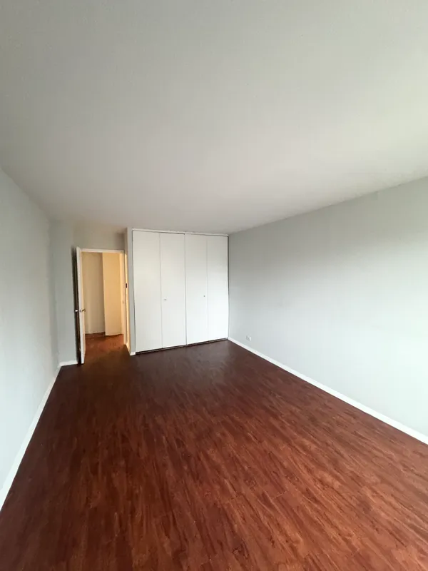 a view of an empty room and wooden floor