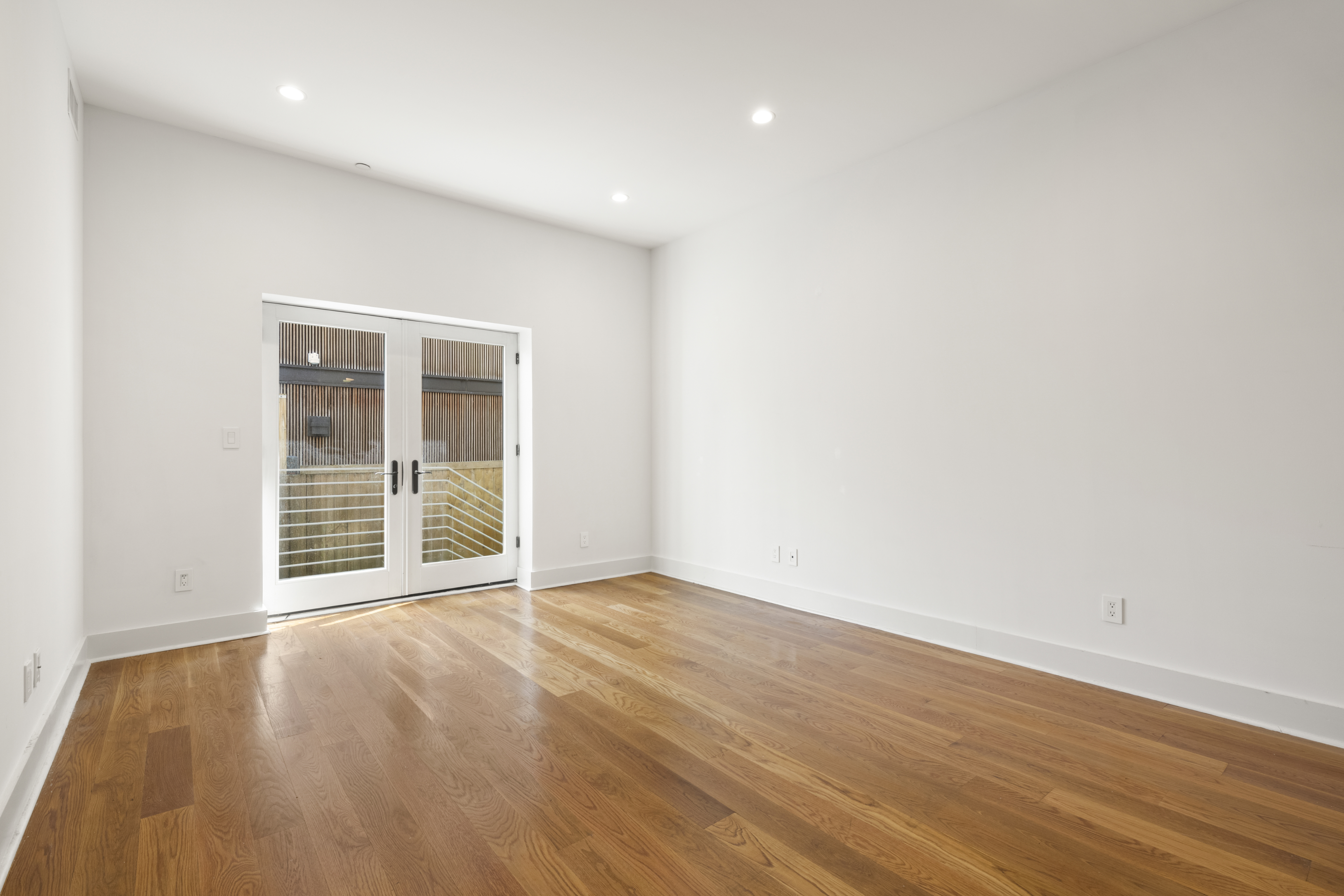 25 Lexington Avenue, Unit 103 Brooklyn, NY 11238 - Photo 2 of 15 an empty room with wooden floor and windows