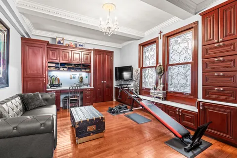 a living room with furniture gym equipment and a large window