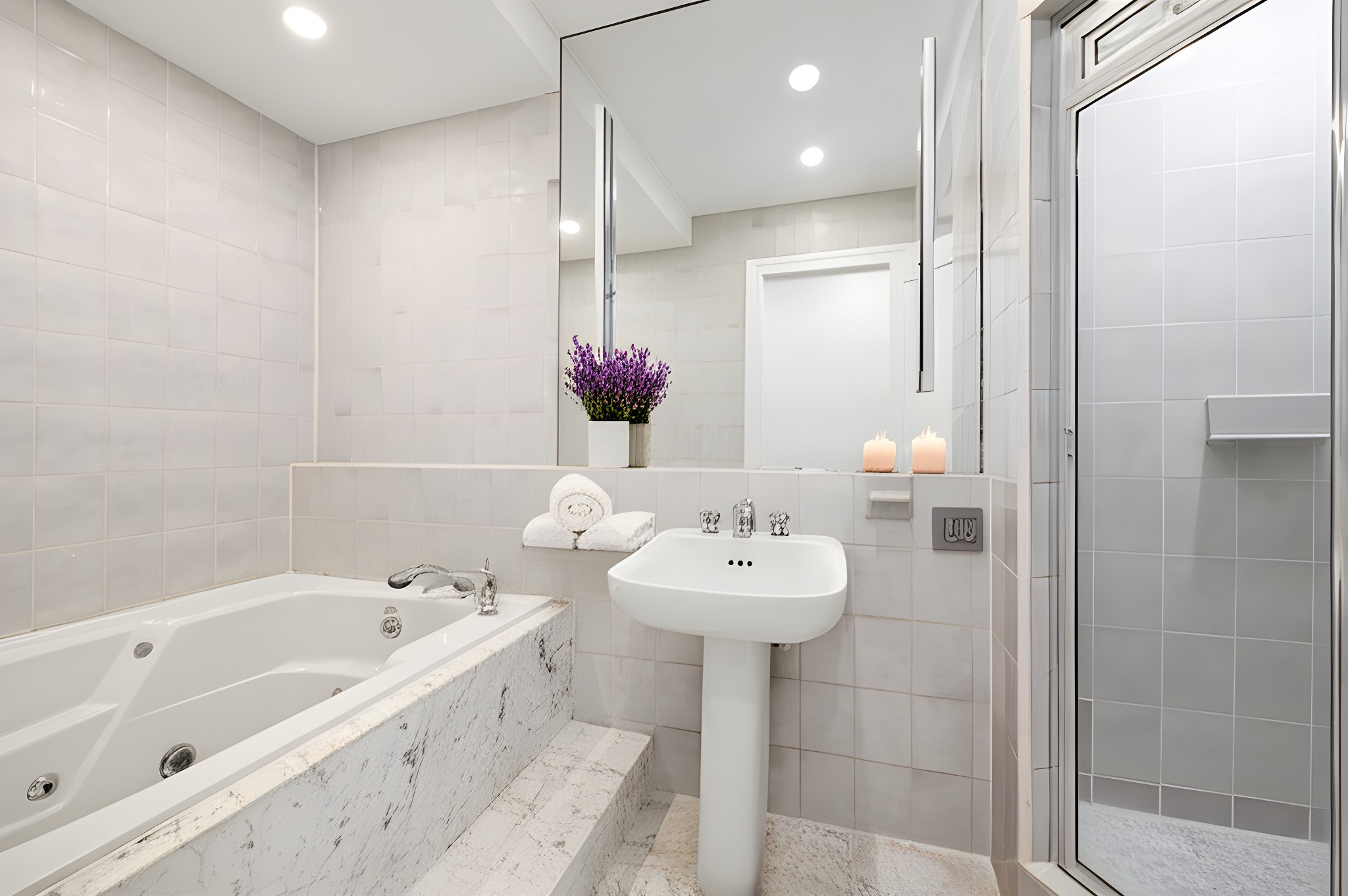 157 East 75th Street, Unit 1E Manhattan, NY 10021 - Photo 6 of 11 a bathroom with a bathtub sink and mirror