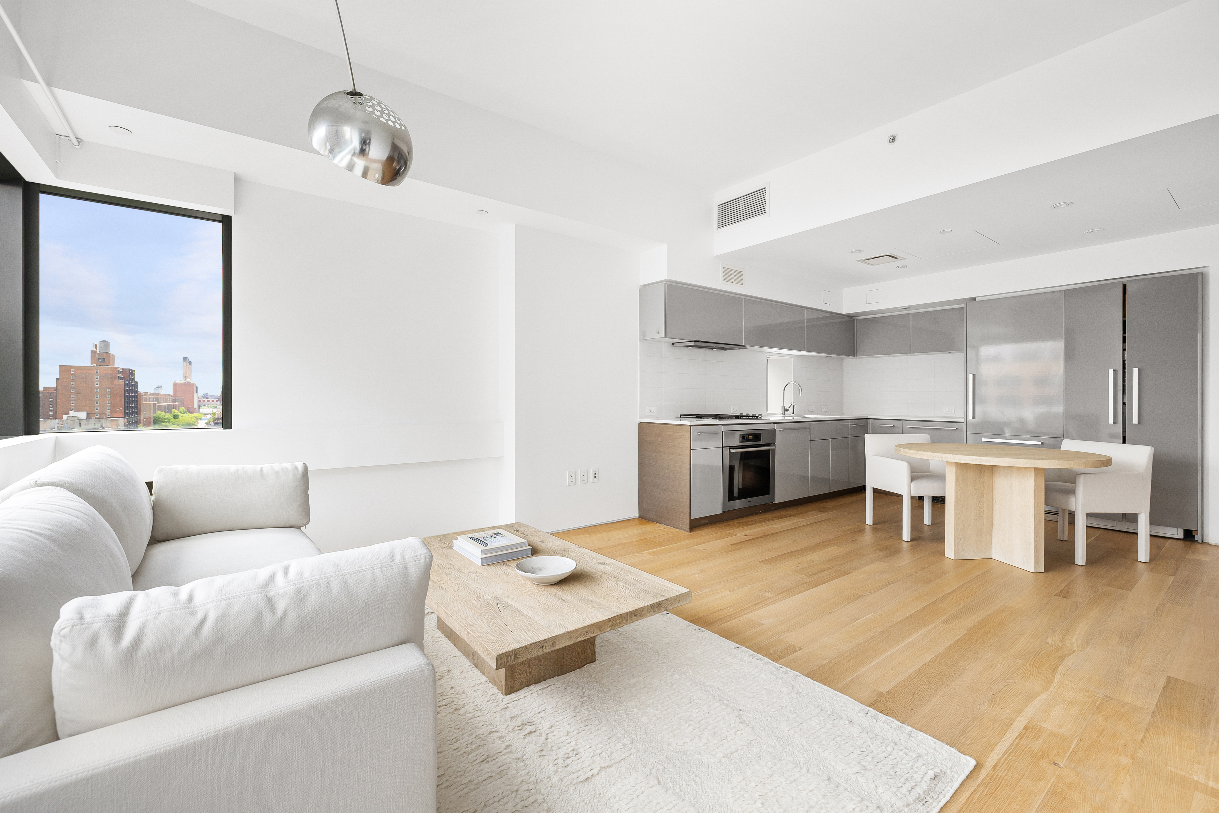 123 3rd Avenue, Unit 9C Manhattan, NY 10003 - Photo 3 of 16 a living room with furniture and kitchen view
