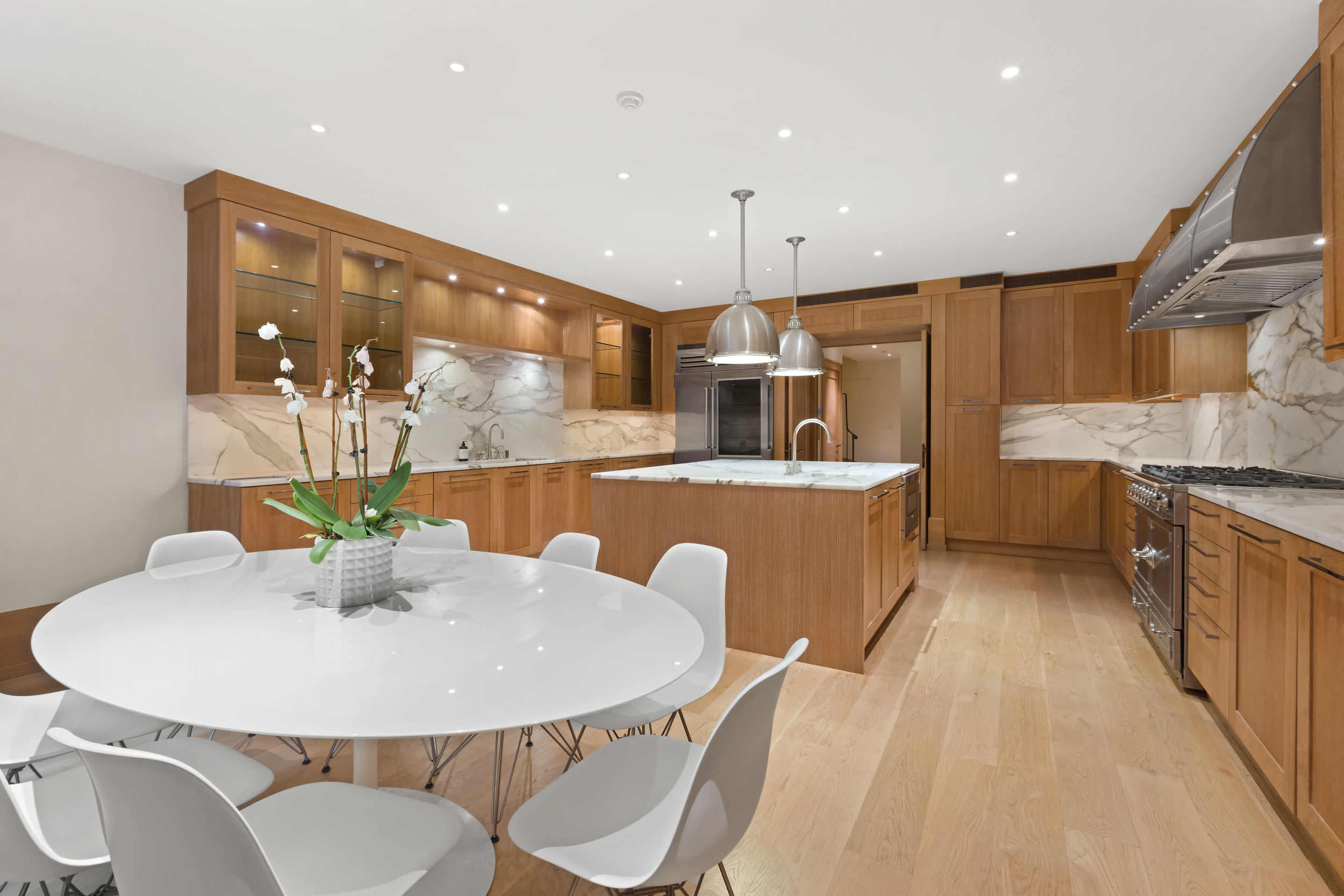 45 East 74th Street Manhattan, NY 10021 - Photo 14 of 33 a kitchen with stainless steel appliances kitchen island granite countertop a sink a refrigerator and a stove