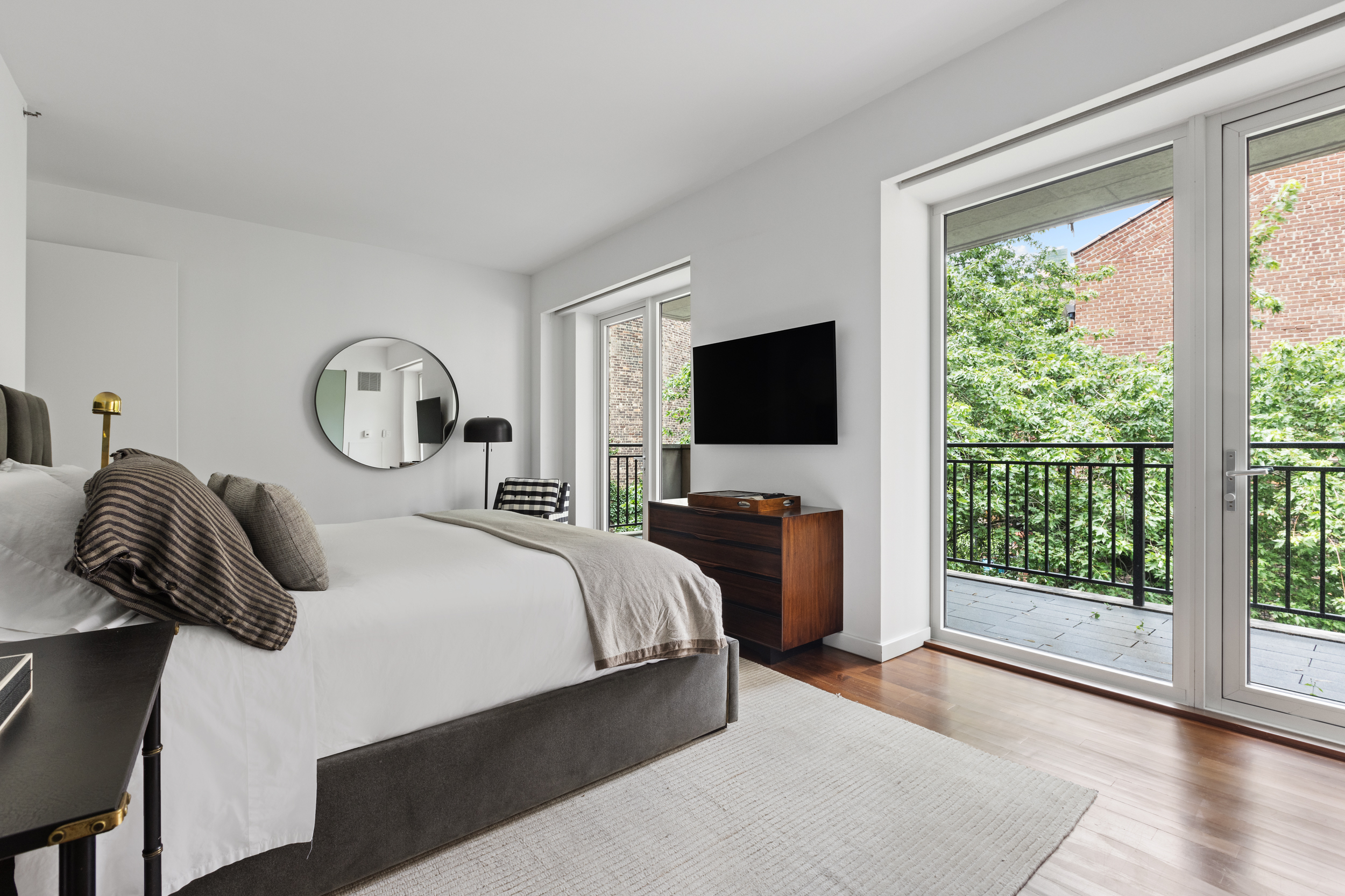 744 Greenwich Street, Unit 4 Manhattan, NY 10014 - Photo 23 of 34 a bedroom with a bed and a flat tv screen on the dresser