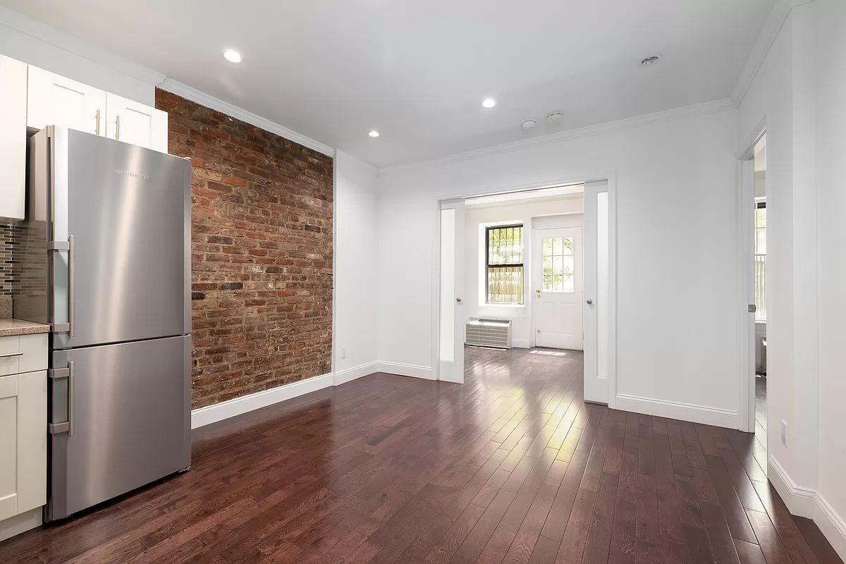328 West 19th Street, Unit 1B Manhattan, NY 10011 - Photo 2 of 11 a view of a refrigerator in kitchen and wooden floor