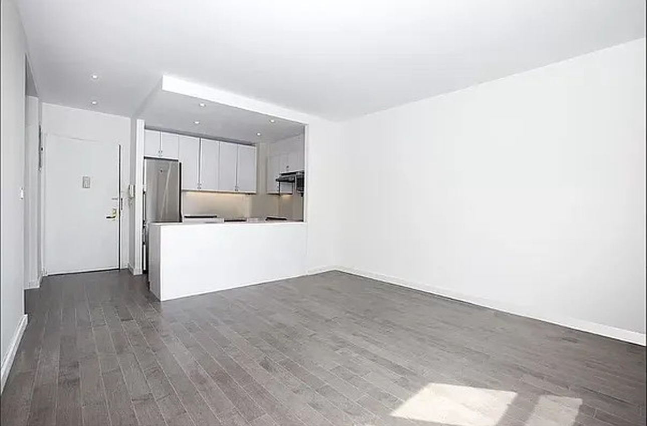 400 East 14th Street, Unit 4C Manhattan, NY 10009 - Photo 1 of 7 a view of a kitchen with wooden floor and electronic appliances