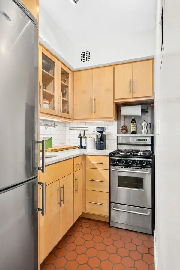 a kitchen with stainless steel appliances a stove sink and cabinets