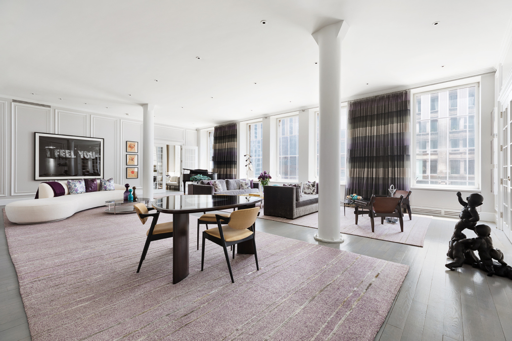 a living room with furniture and large windows