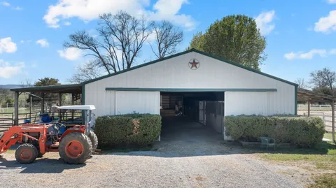 a view of a car in front of garage